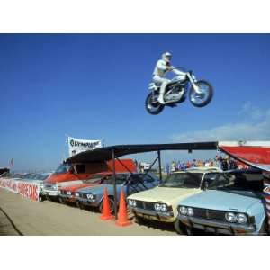  Daredevil Motorcyclist Evil Knievel in Mid Jump over a Row 