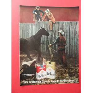 com Marlboro cigarettes,1969 print advertisement (men on fence/horse 