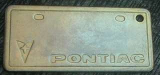 Vintage solid brass key fob advertising PONTIAC. Measures 2 1/2 