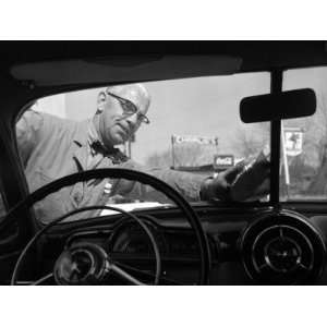 Service Station Attendant in a Bow Tie Washing Customers Windshield 