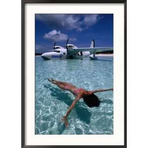 Female Floating in Crystal Waters in Front of Seaplane, Bahamas Framed 
