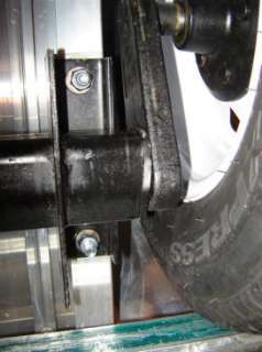 THIS PHOTO SHOWS THE TORSION AXLE MOUNTED TO THE UNDERSIDE OF A 