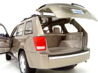 Brand new 118 scale diecast 2005 Jeep Grand Cherokee GOLD by Maisto.