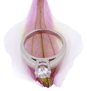 Solitaire diamond ring with a prong setting on a pink flower petal