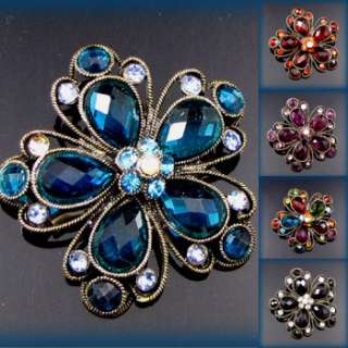   brooch pin with sparkling rhinestones and color glass glaze is the