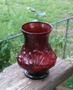 This is a excellent Ruby glass vase A raised flower design Damage free 