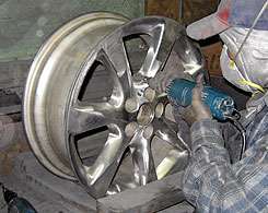 Polishing detail areas of the wheel with hand tools