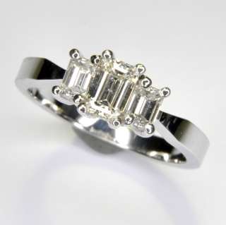 Diamond three stone past, present, future ladies ring. Emerald cut 